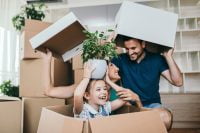 Happy first-time homebuyer symbolizing buying a home with little to no down payment